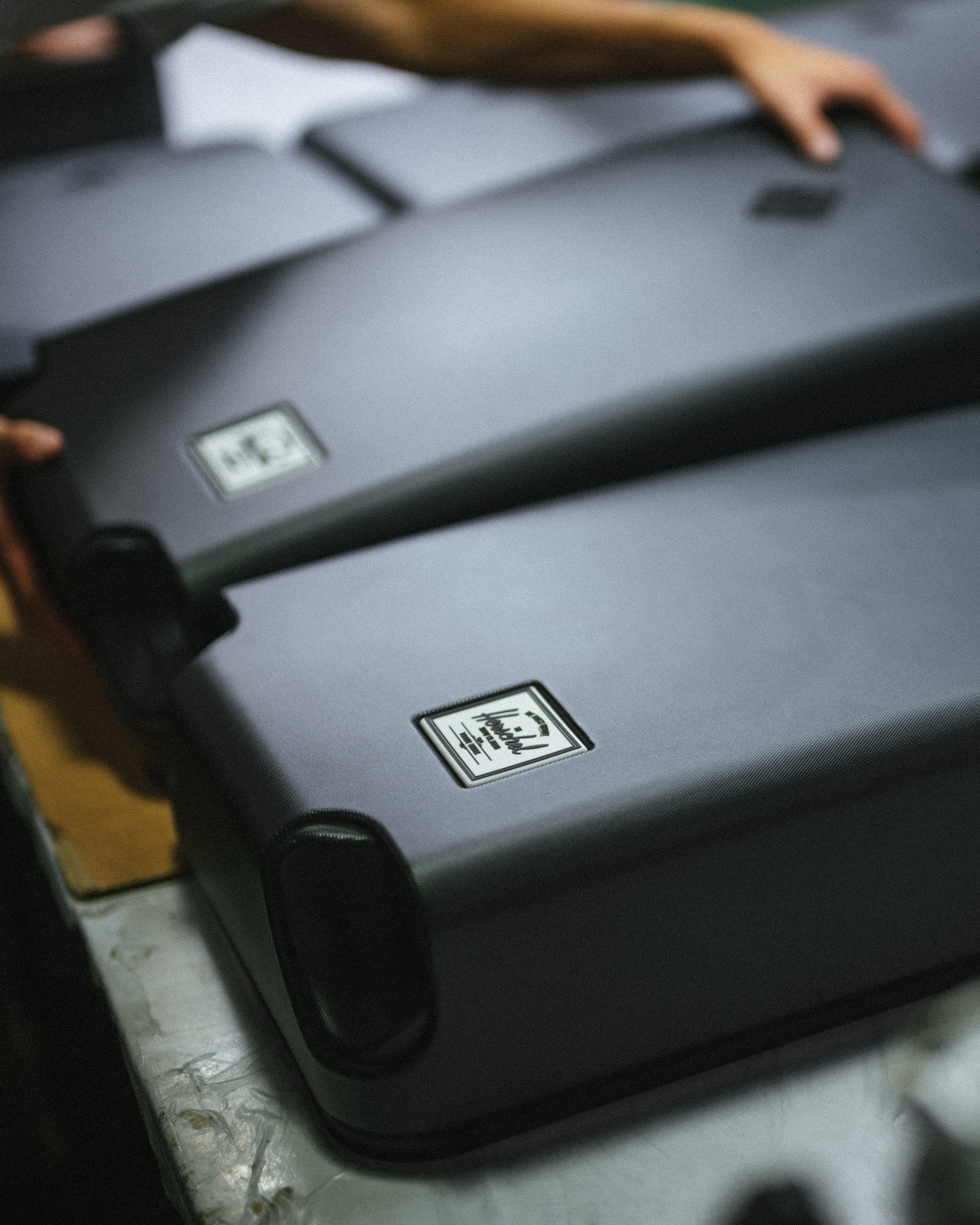 Herschel Supply Co. x Realtree limited-edition collection essential bags, apparel, and accessories arranged together in the APX camouflage pattern.