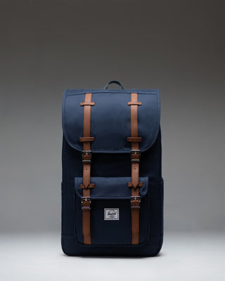 Navy blue Herschel Little America Backpack with classic front pocket and brown fastening straps.