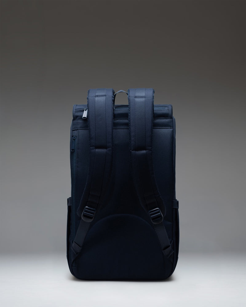 Herschel Little America Backpack in navy blue, featuring classic mountaineering style with front straps and buckles.