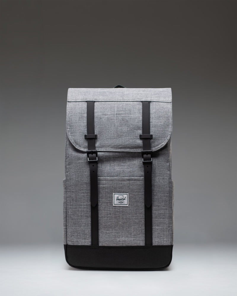 Herschel Retreat Backpack in Raven Crosshatch, featuring a classic cinched design with magnetic strap closures and a front storage sleeve.