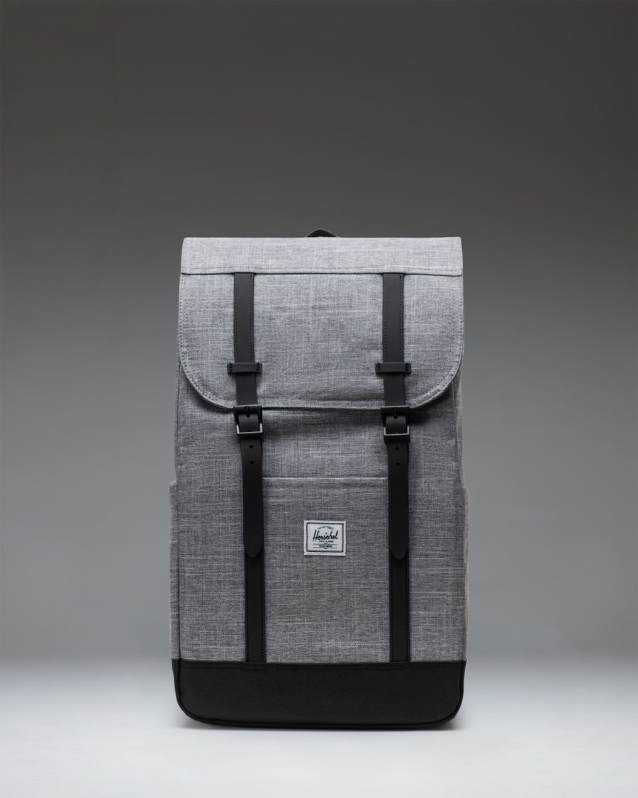 Herschel Retreat Backpack in Raven Crosshatch, featuring a classic cinched design with magnetic strap closures and a front storage sleeve.