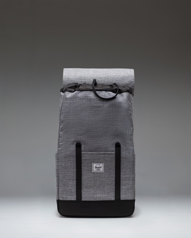 Herschel Retreat Backpack in Raven Crosshatch grey with a drawcord cinch closure and black magnetic strap closures.