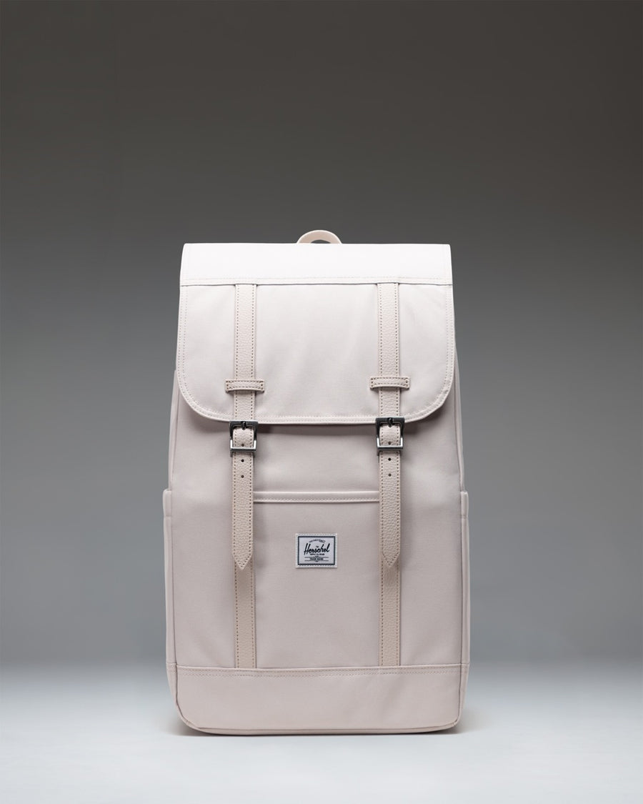 Herschel Retreat Backpack 23L in Moonbeam creme-white color with magnetic strap closures and dual water bottle pockets.