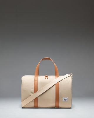 Herschel Novel Carry On Duffle in Eucalyptus green, showing a side view with a zippered shoe compartment.