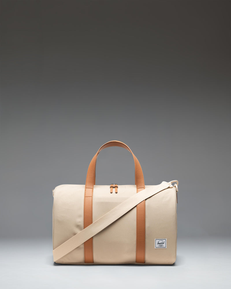 Herschel Novel Carry On Duffle in Eucalyptus green, showing a side view with a zippered shoe compartment.