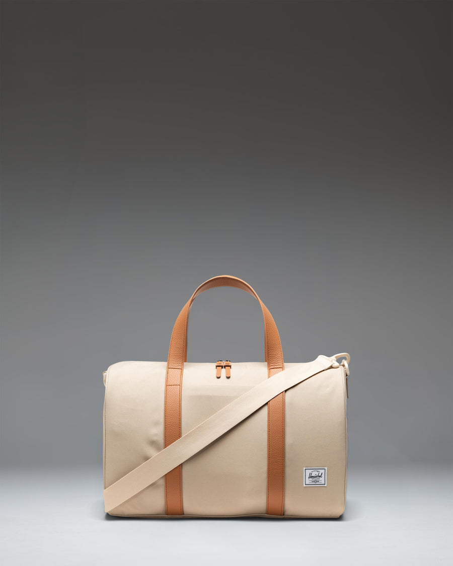 Herschel Novel Carry On Duffle in Eucalyptus green, showing a side view with a zippered shoe compartment.