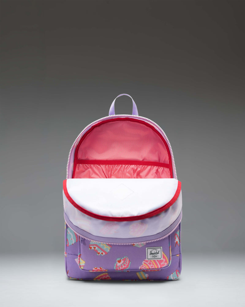 Herschel Heritage Youth Backpack featuring a playful cake-themed print with a spacious main compartment and a front pocket.
