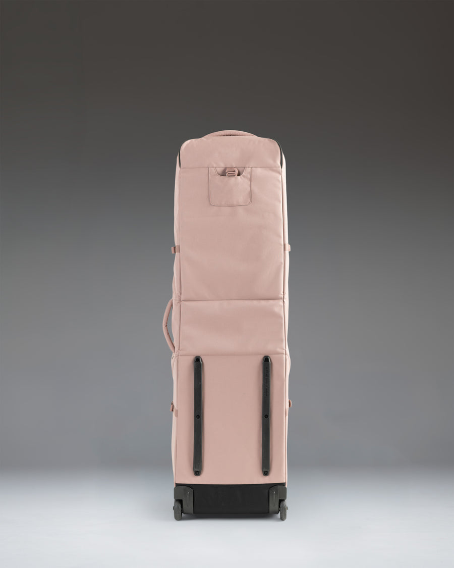 Herschel Supply Co. Heritage Golf Travel Wheelie Bag in Ash Rose pink, showcasing its durable exterior, wheels, and spacious design.