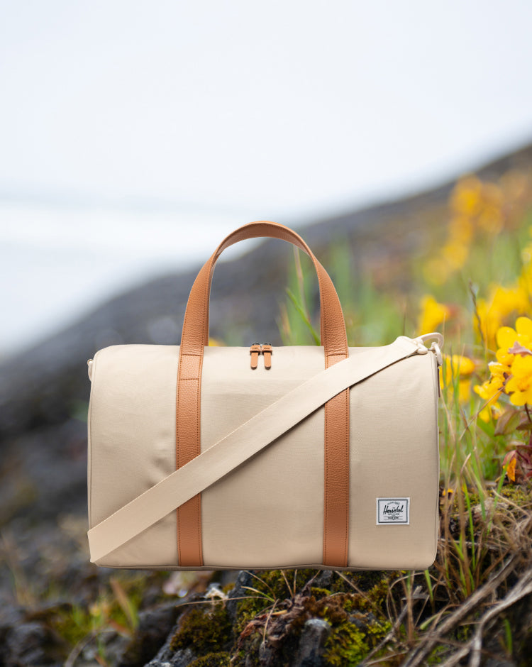 Herschel Novel Carry On Duffle in Eucalyptus green, showing a mobile view of the travel bag.